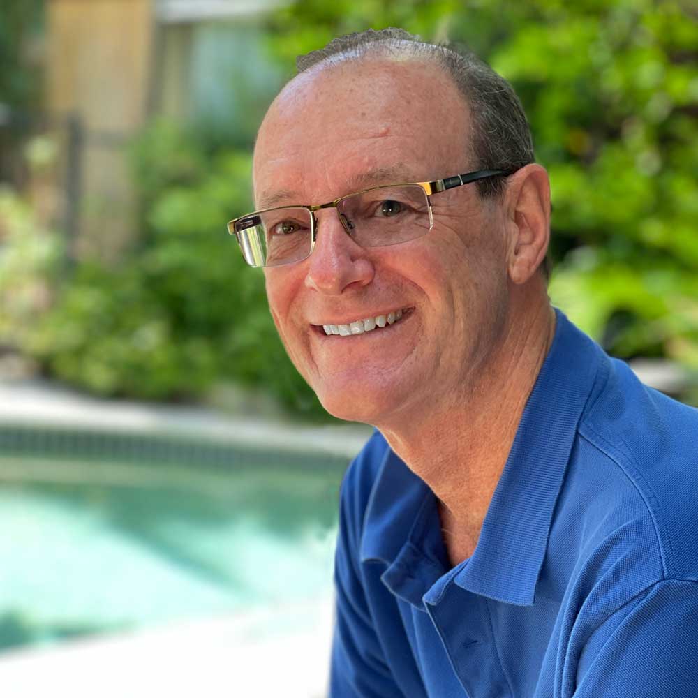 Paul Hindes sitting by the pool in Sunrise Beach